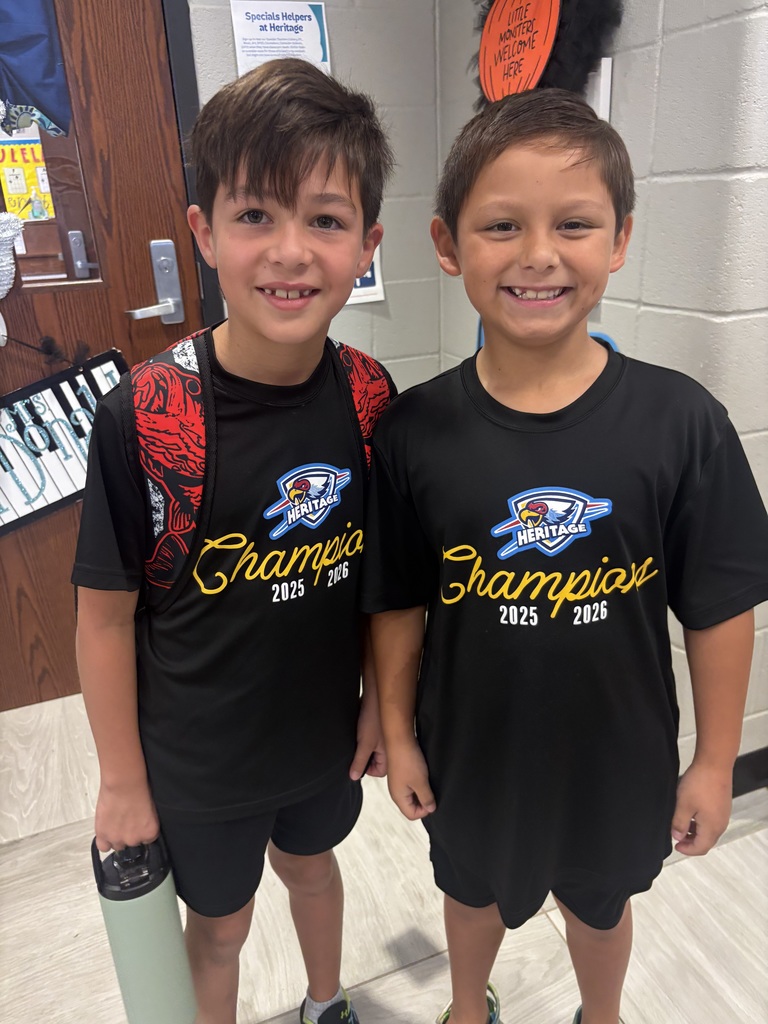 Two boys smiling wearing matching outfits