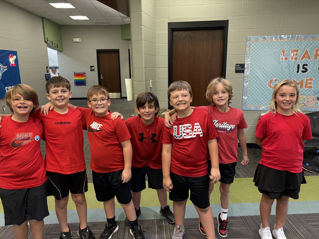 Group of boys smiling wearing matching outfits