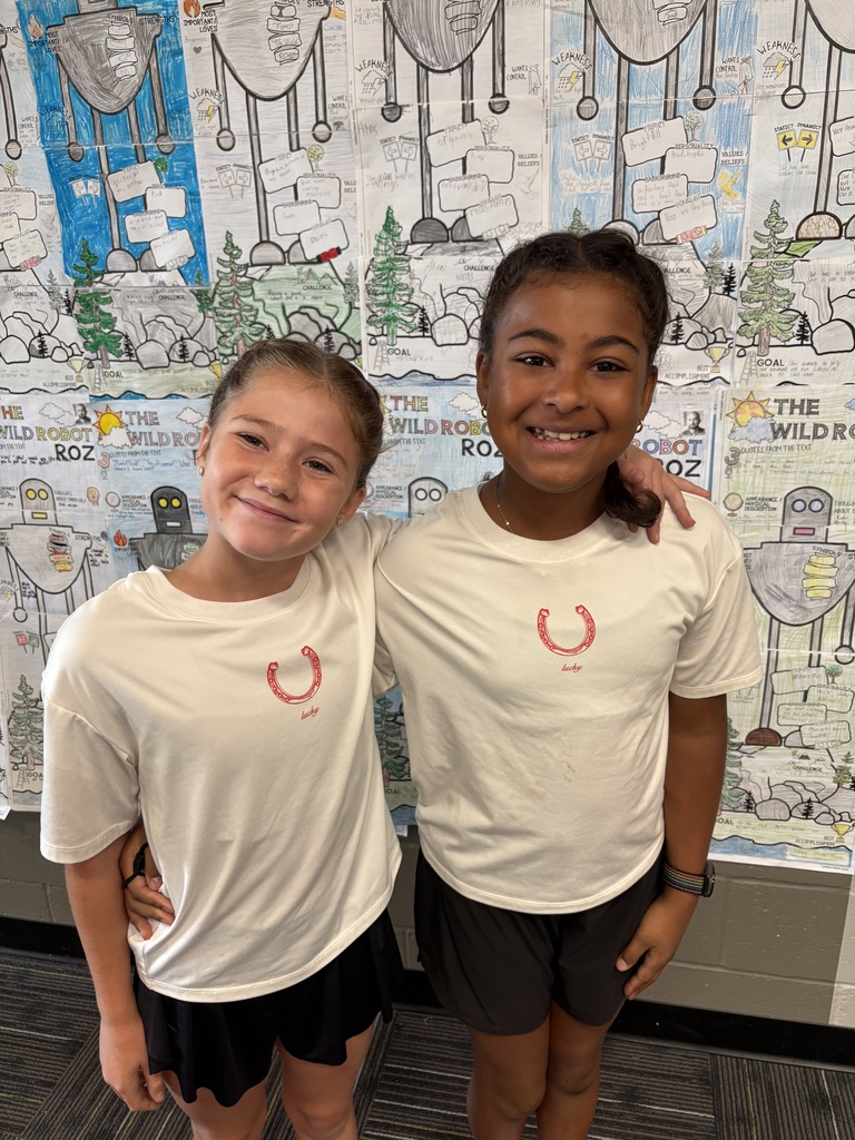Two girls smiling wearing matching outfits