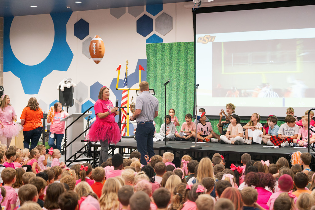 brandon weeden getting handed a trophy at an assembly