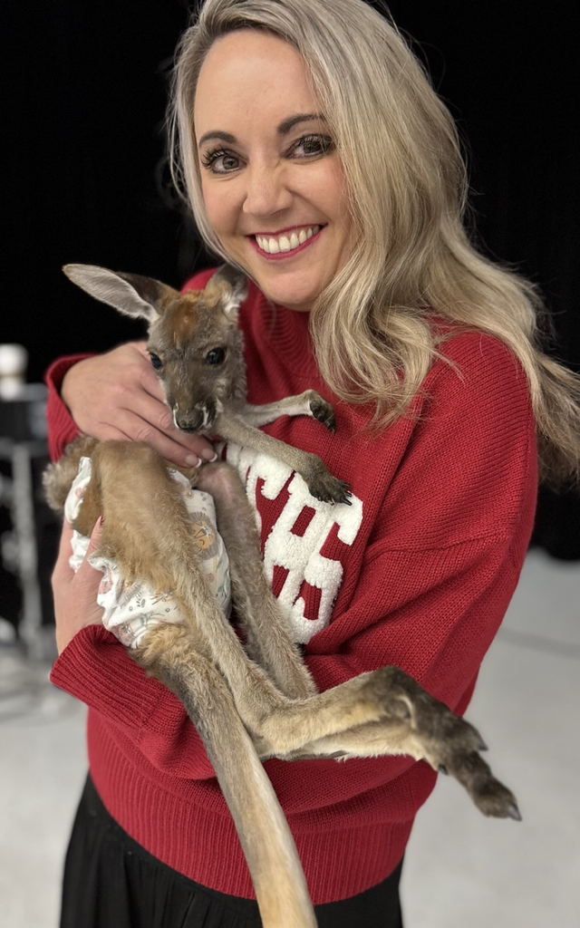 Mrs Williams kissing a Joey 