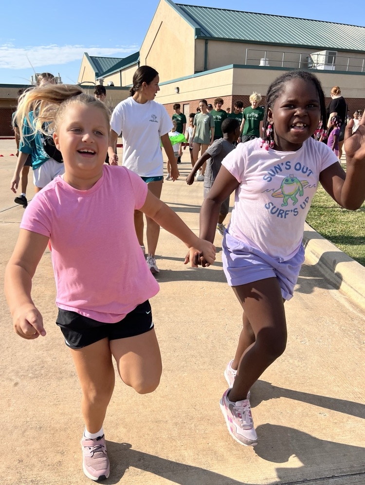 students running and holding hands 