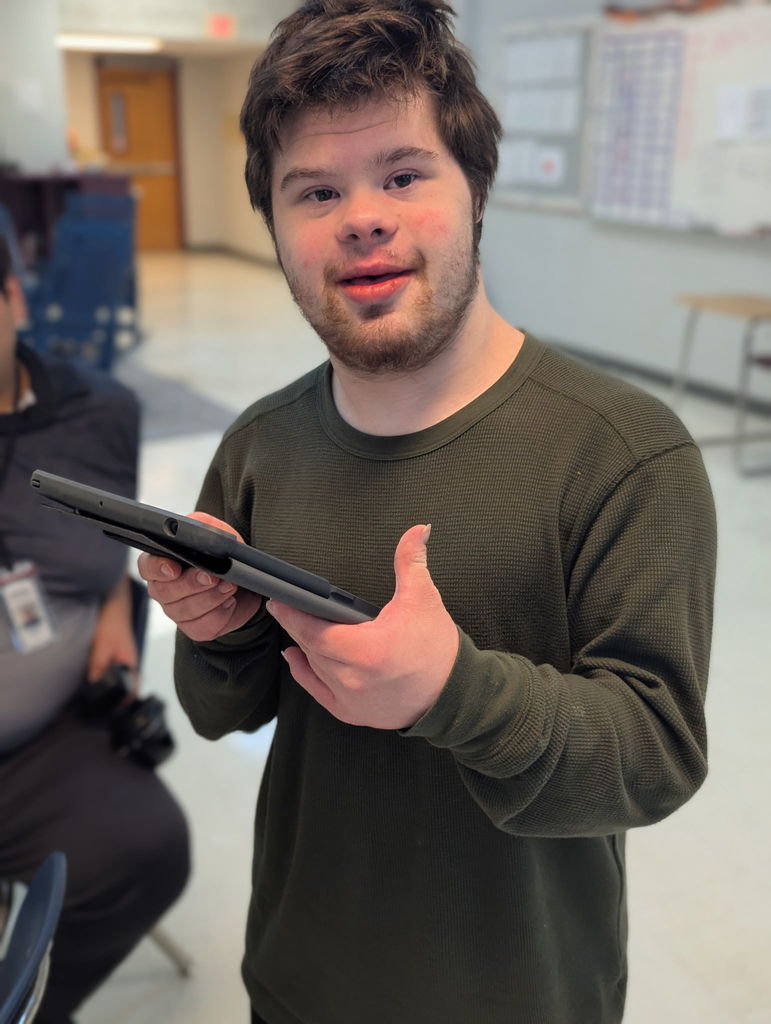 An intern with an IPAD waiting to take a customers order