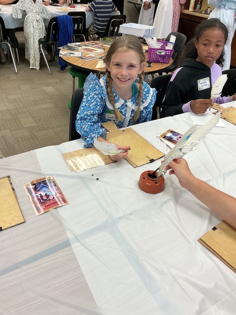 students writing with quill pens
