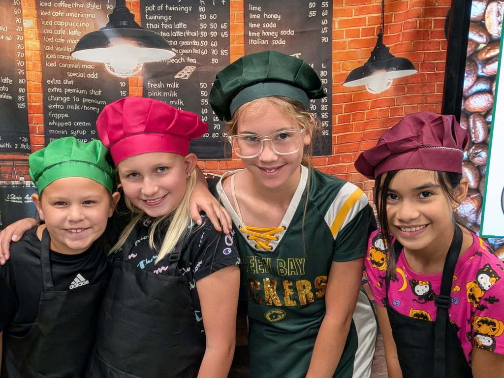 4 students dressed as chefs