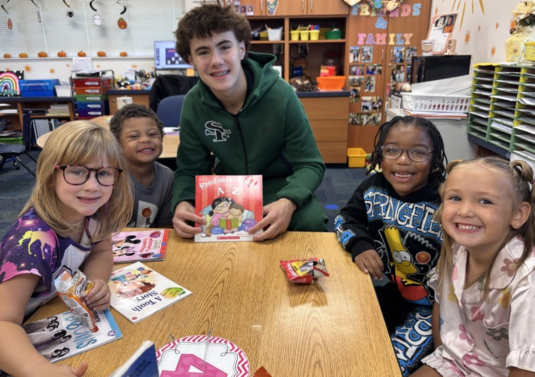 high school basketball player with kindergarten kids 