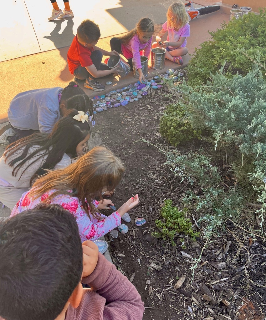 Kids putting rocks in the garden