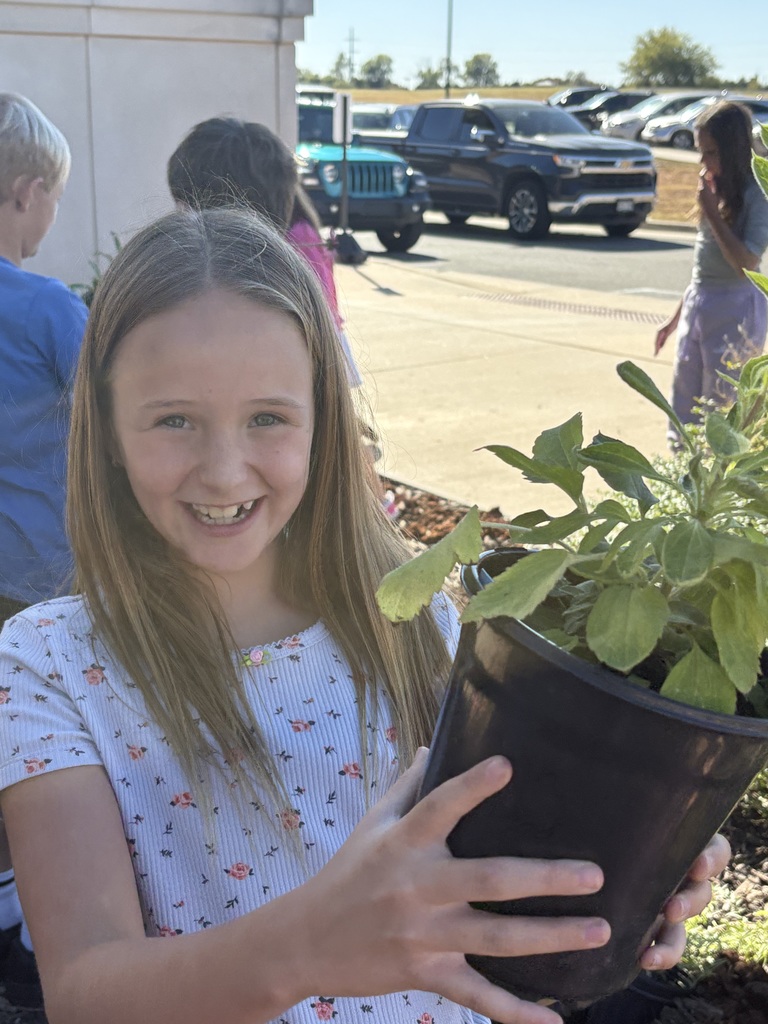Girl smiling with a plant