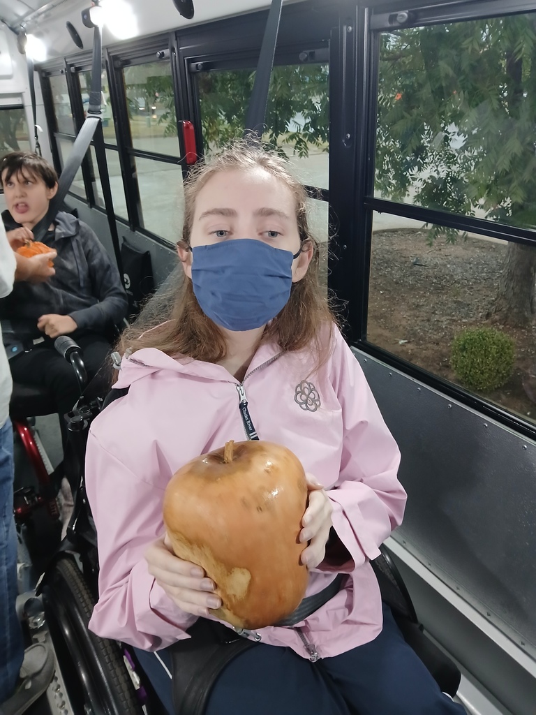 Intern holding a noise-making pumpkin