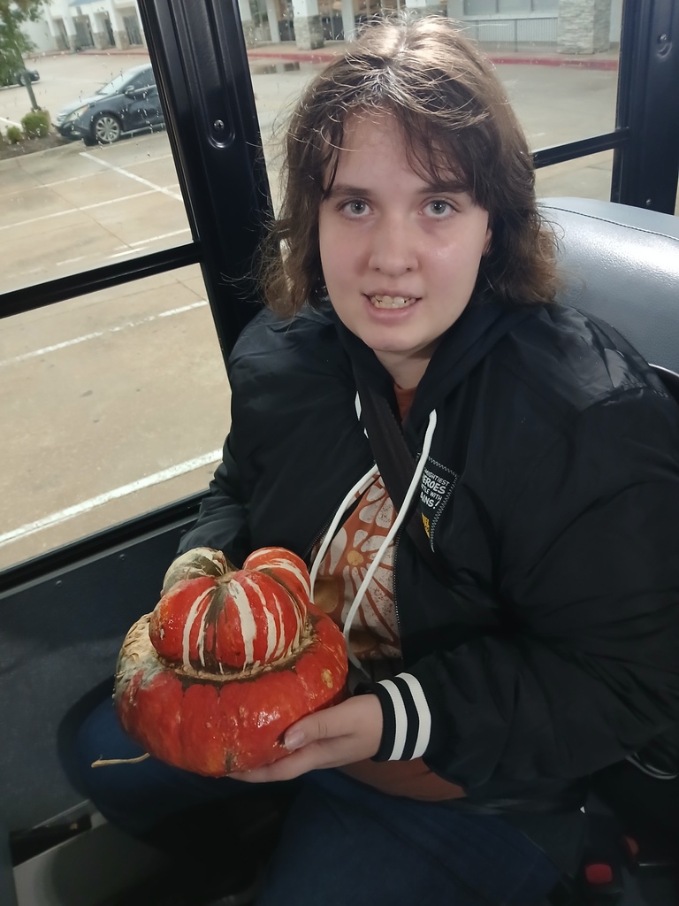 An intern holding a  gourd.