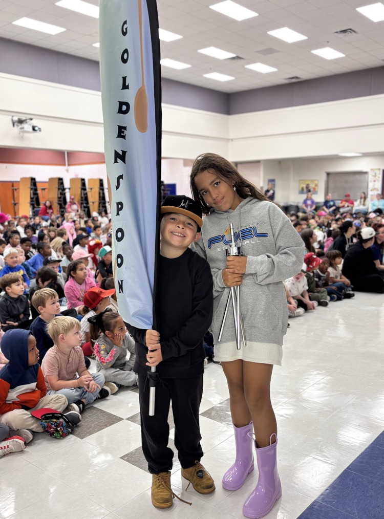 students holding golden spoon flag 