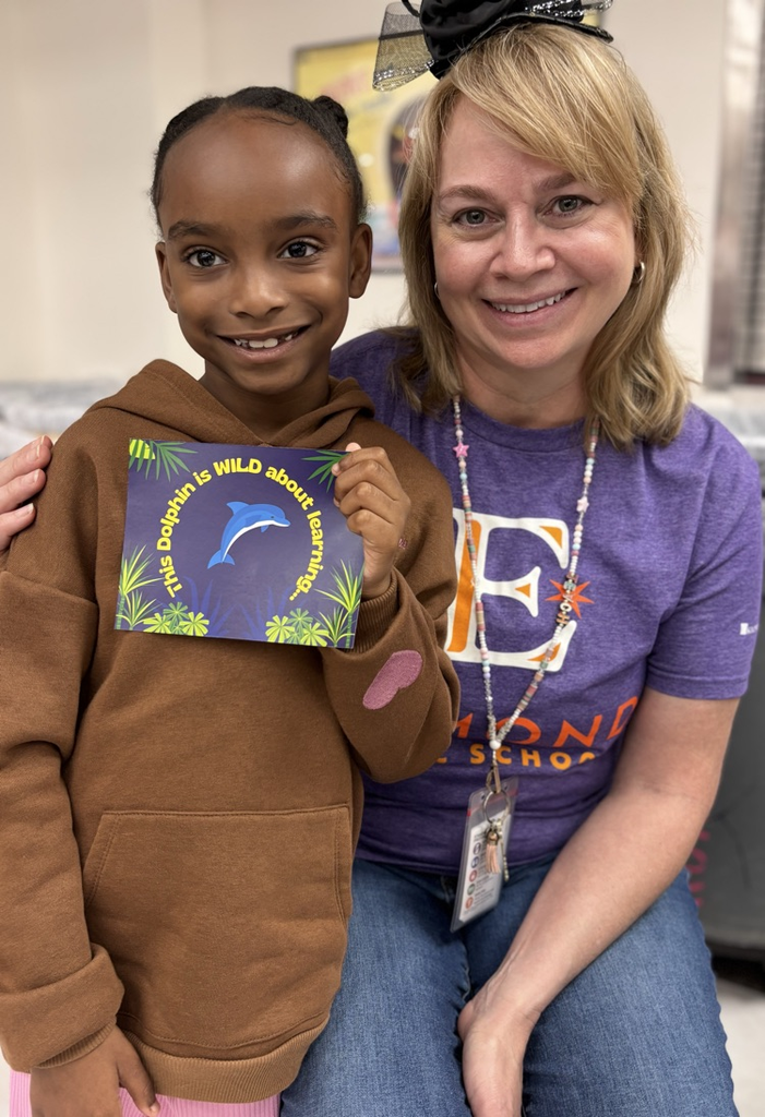student with teacher receiving award 