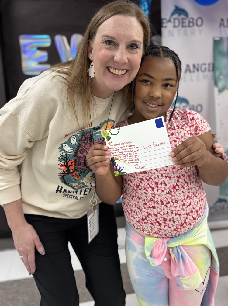 student with teacher receiving award 