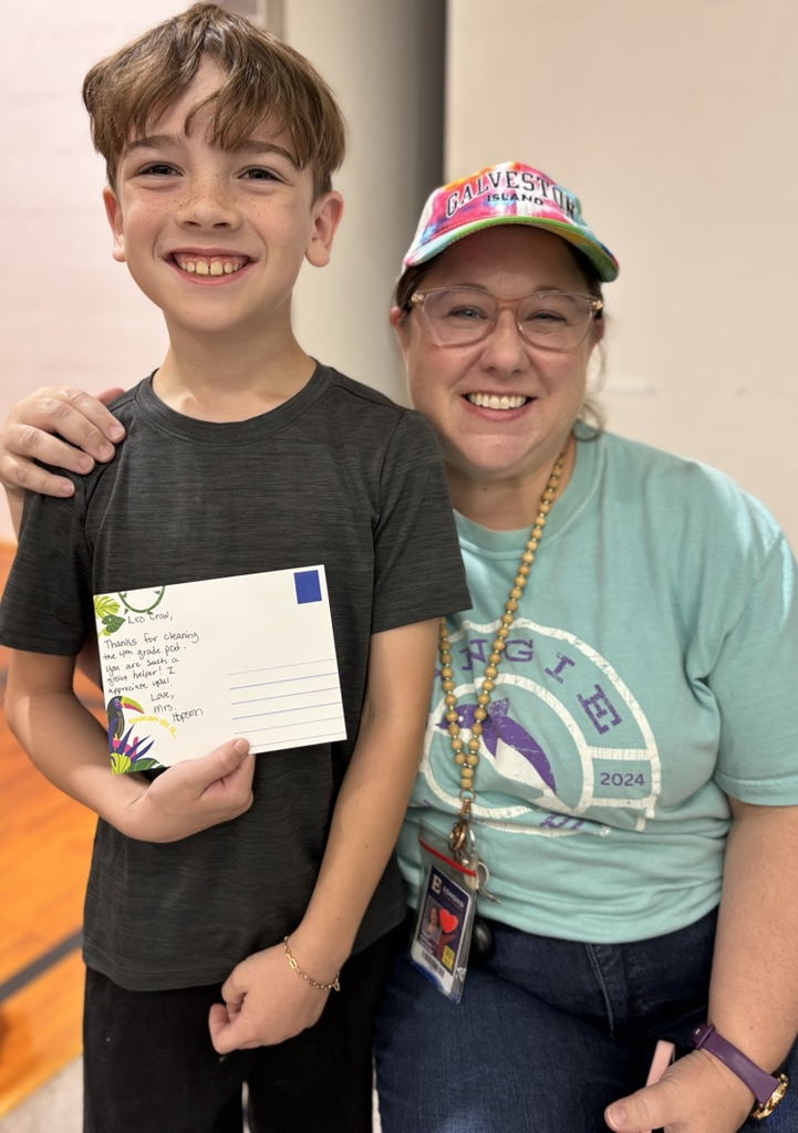 student with teacher receiving award 