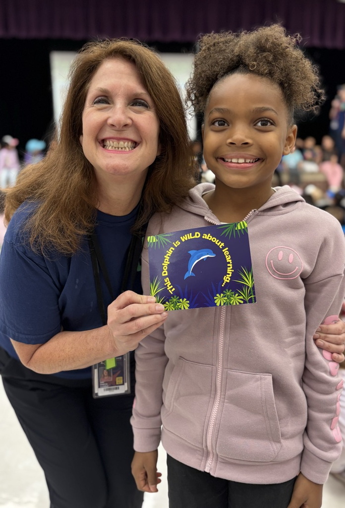 student with teacher receiving award 