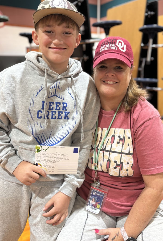student with teacher receiving award 