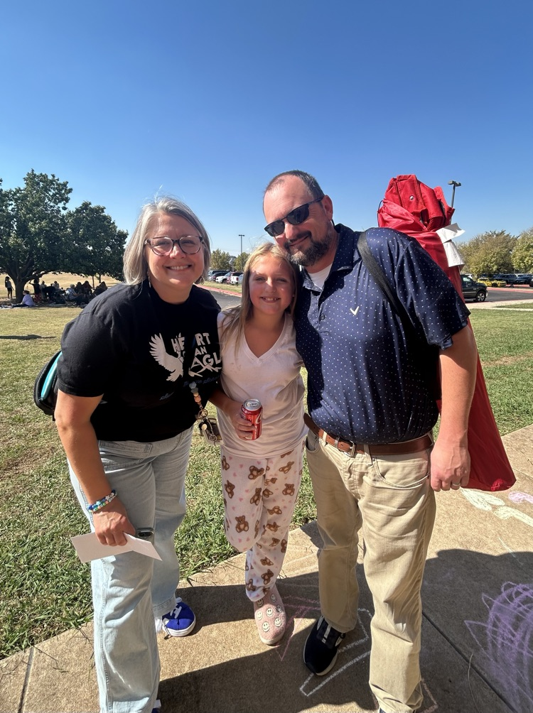 student with parents at cookout 