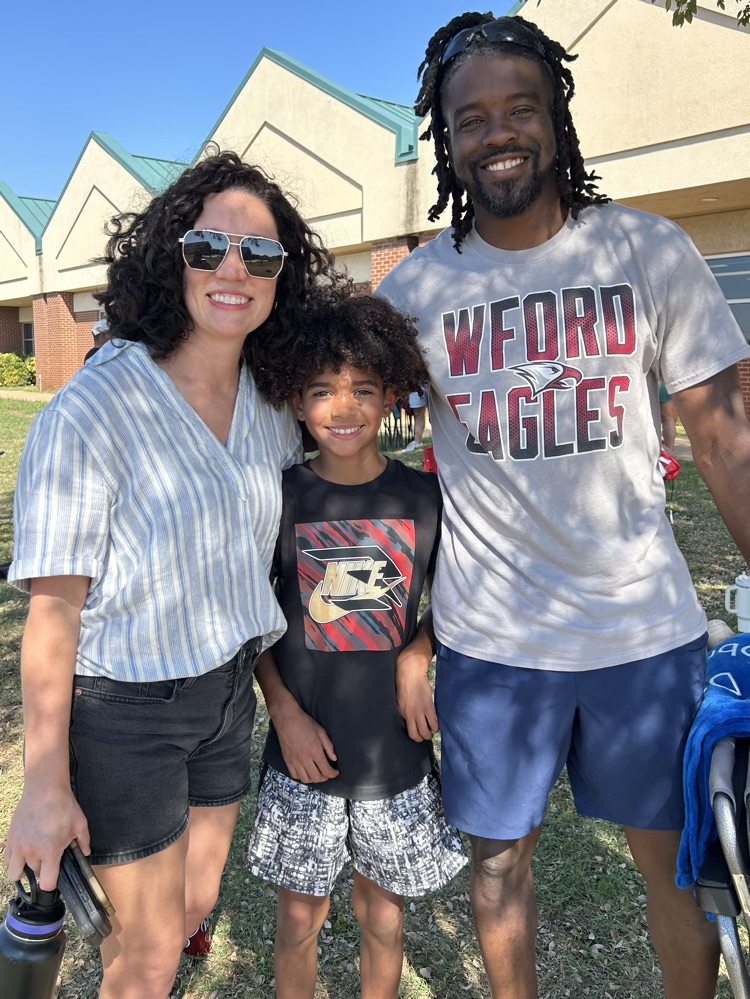 student with parents at cookout 