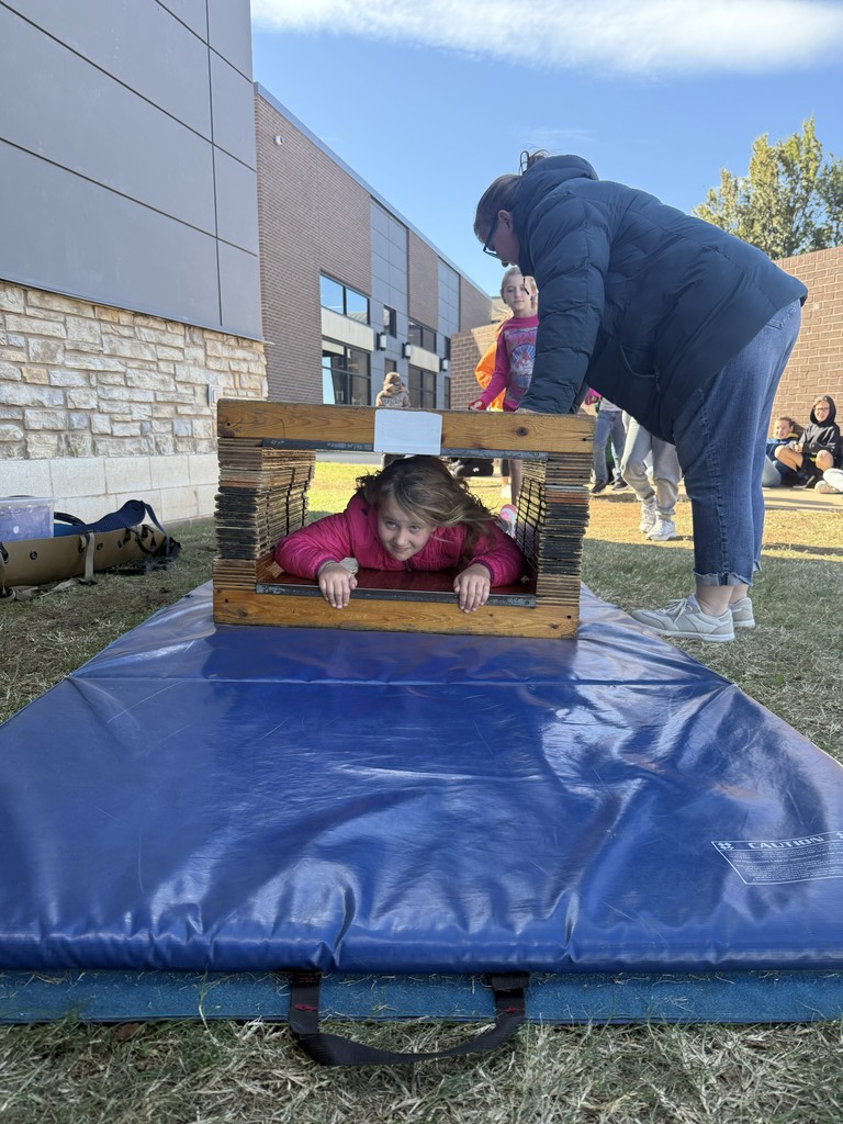 student in squeezing through cave simulator