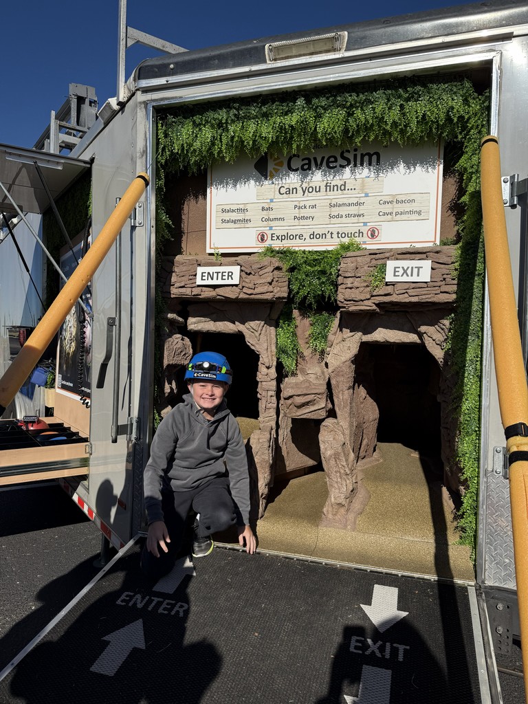 student in front of cave simulator