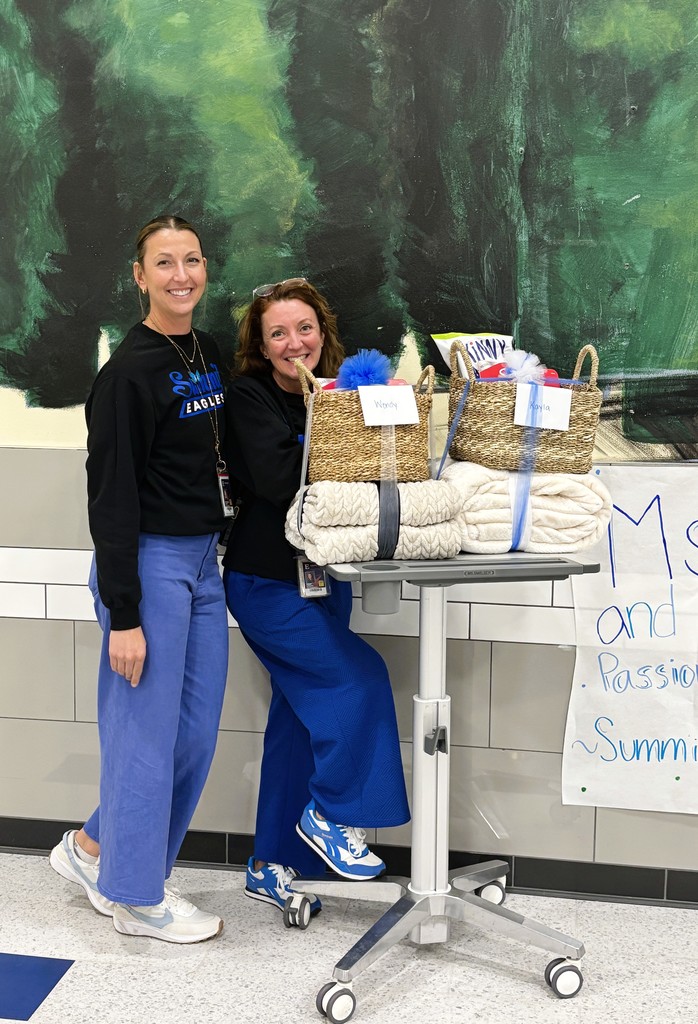 Mrs. Pedretti and Ms. Smelser pose by their appreciation baskets for National Principals Month.