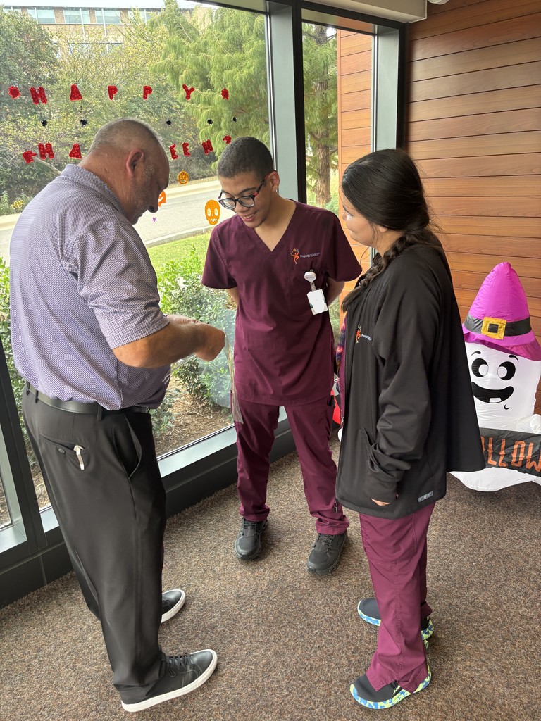 Interns decorating the entry with a hospital manager.