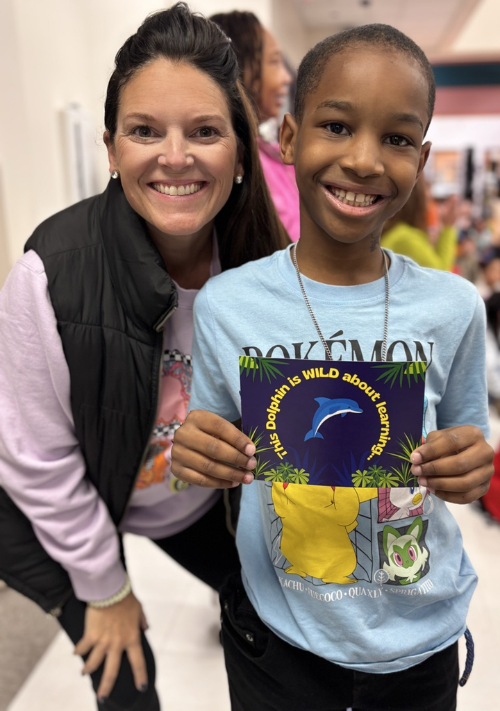 student and teacher with award 