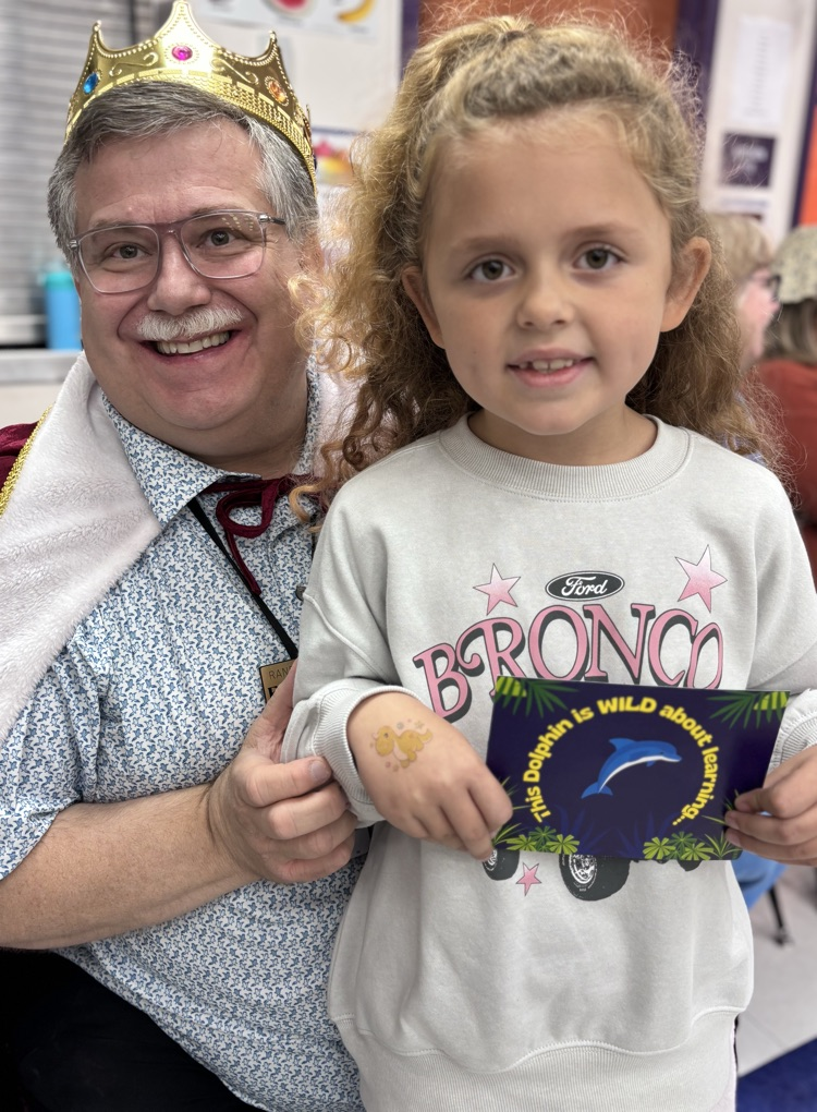student and teacher with award