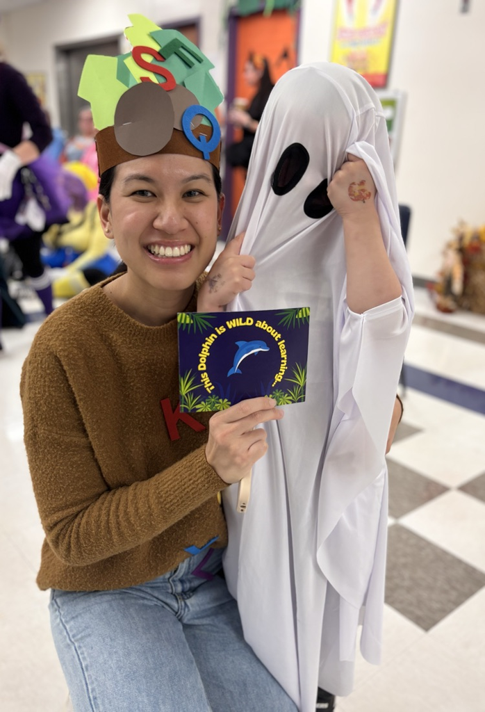 student and teacher with award 