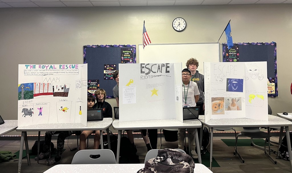 students standing next to their projects