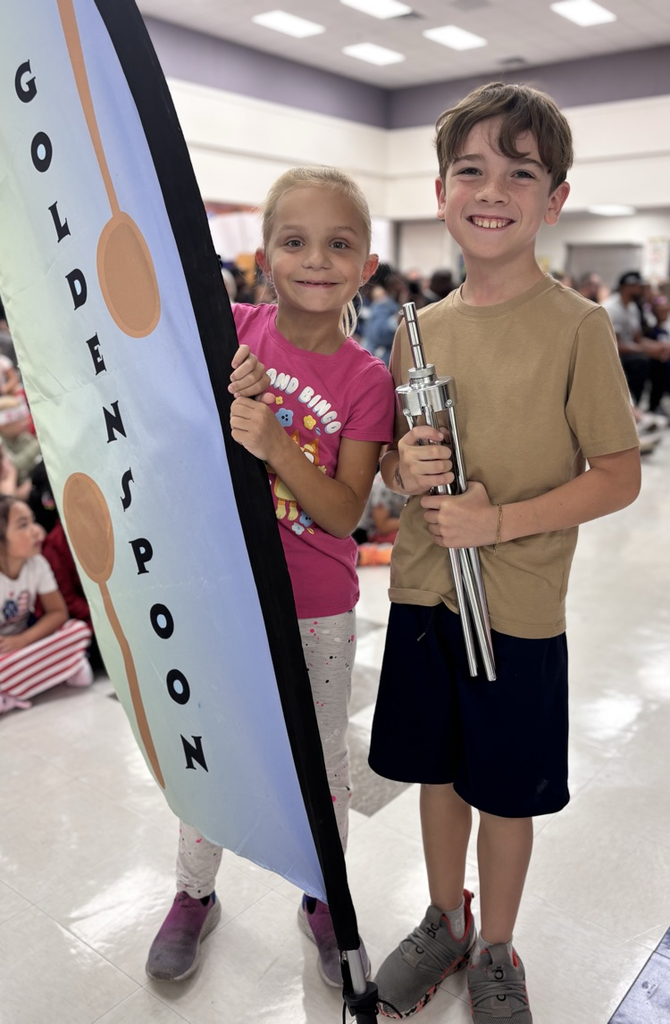 students holding golden spoon flag 
