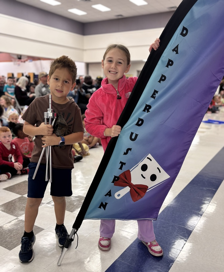 students holding dapper dustpan flag 