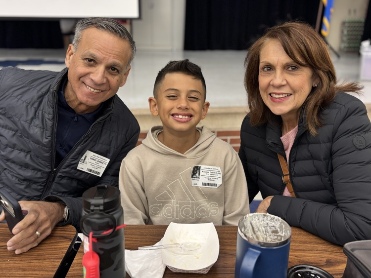student with grandparents at lunch 