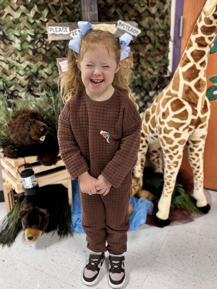 student smiling in front of the book fair 