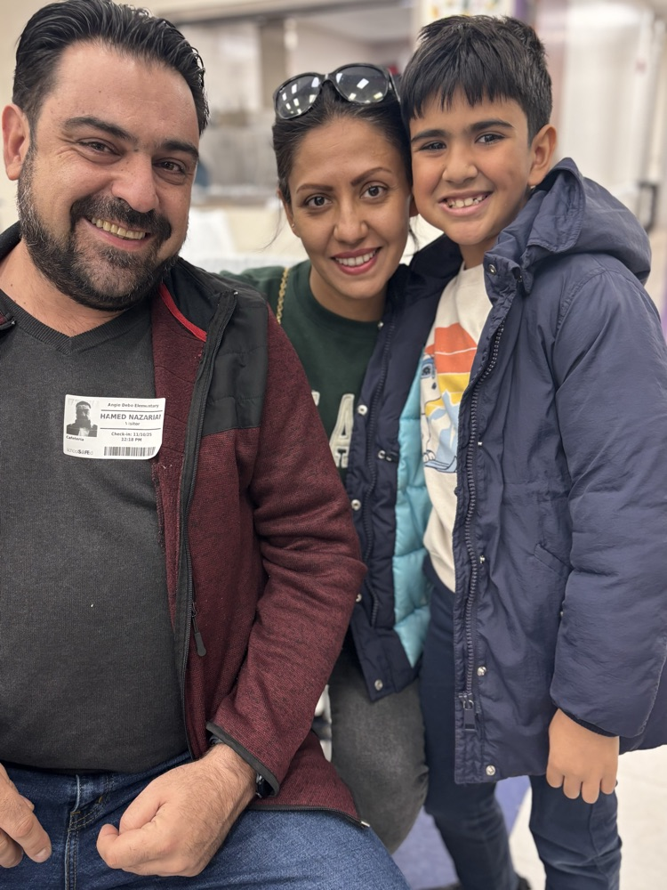 student and parents at lunch 