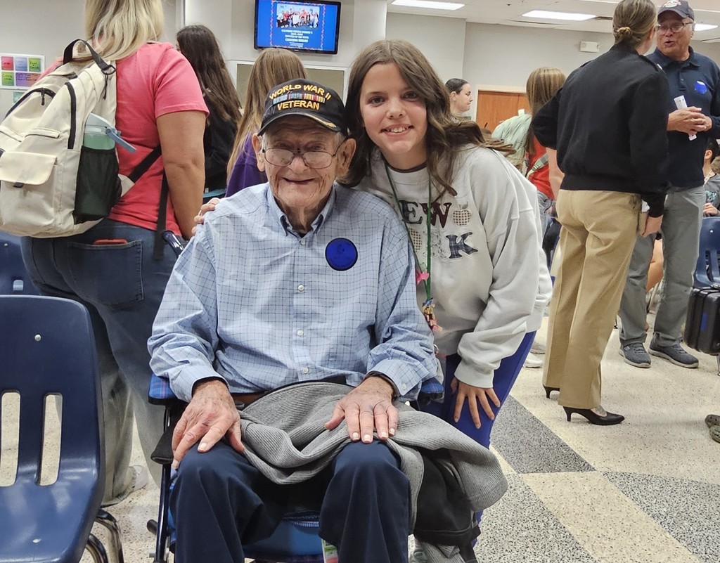 WWII veteran, Ed Edmiston with his granddaughter posing for a picture
