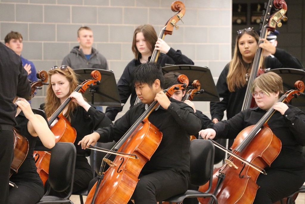 orchestra students performing during assesmbly
