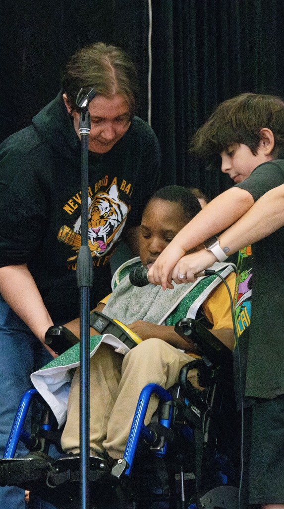 student and teacher helping student speak
