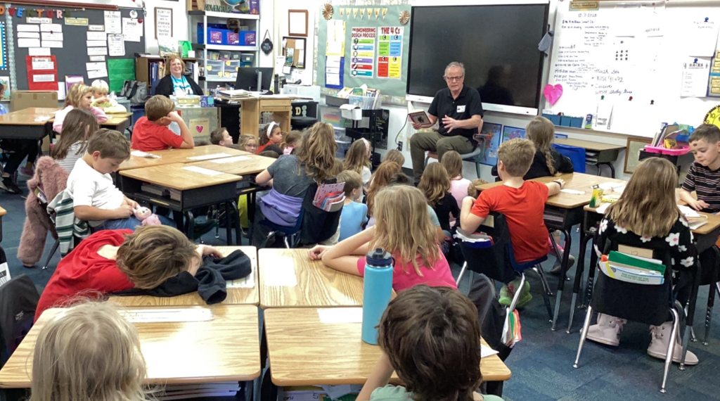 Leo Clarke reads to third graders.