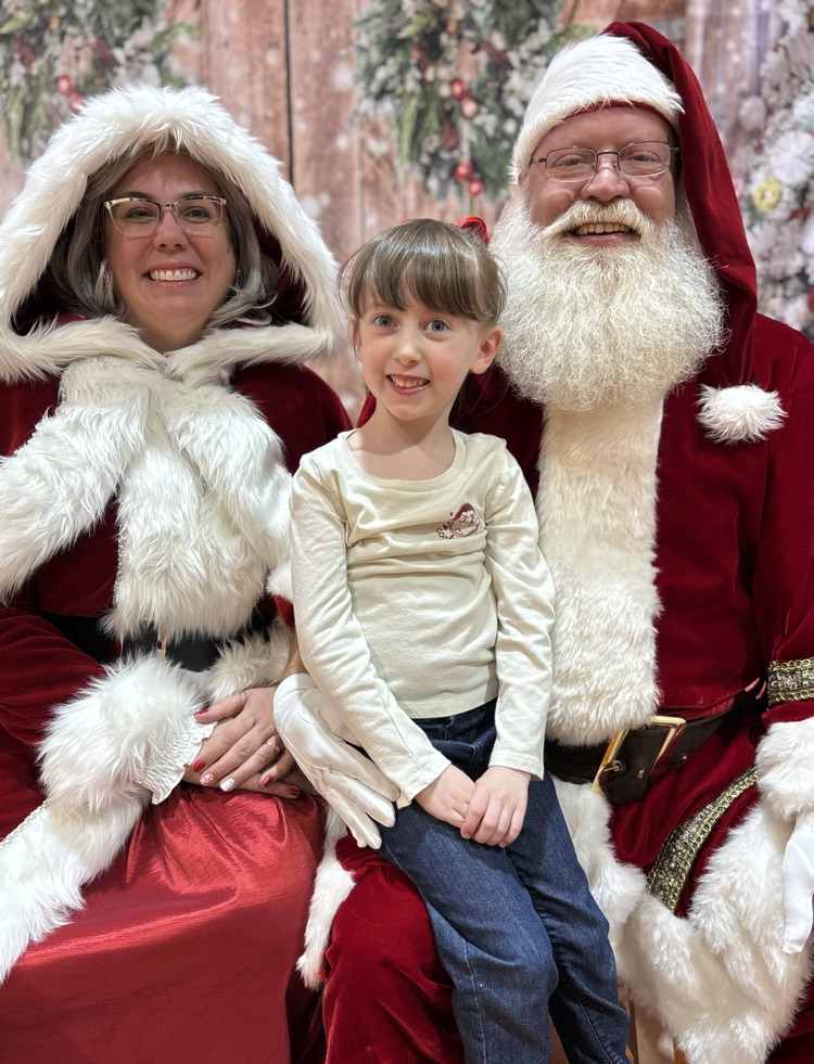 student with Santa and Mrs clause 