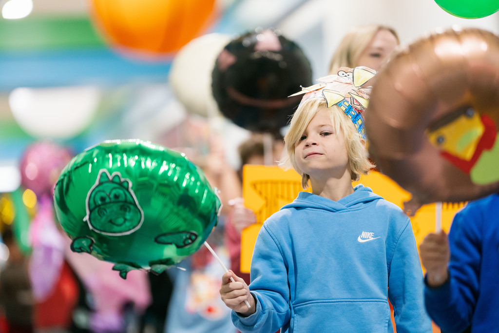 students walking with balloons down the hallways