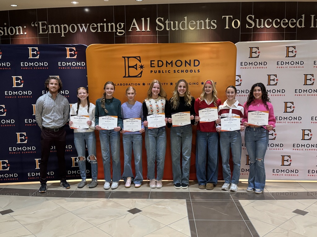 cross country team holding up awards