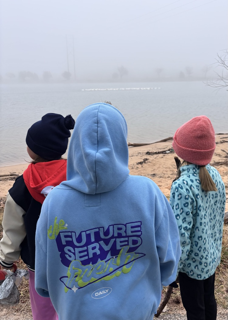 students looking at pelicans in water 