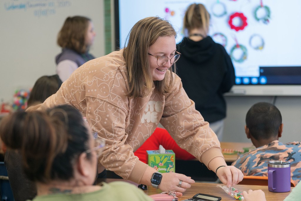 students making ornaments with the help of their teachers