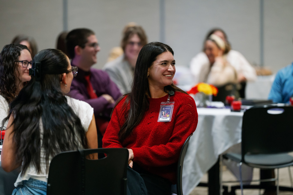 woman at a table smiling