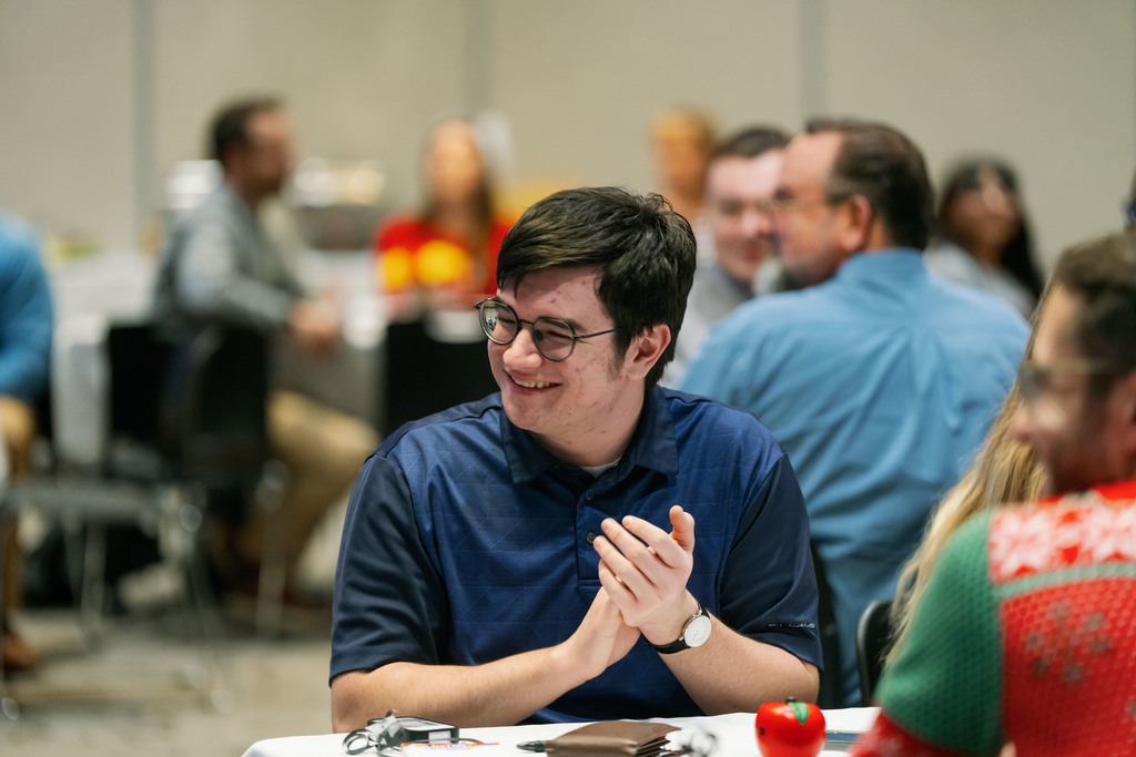 man at a table smiling