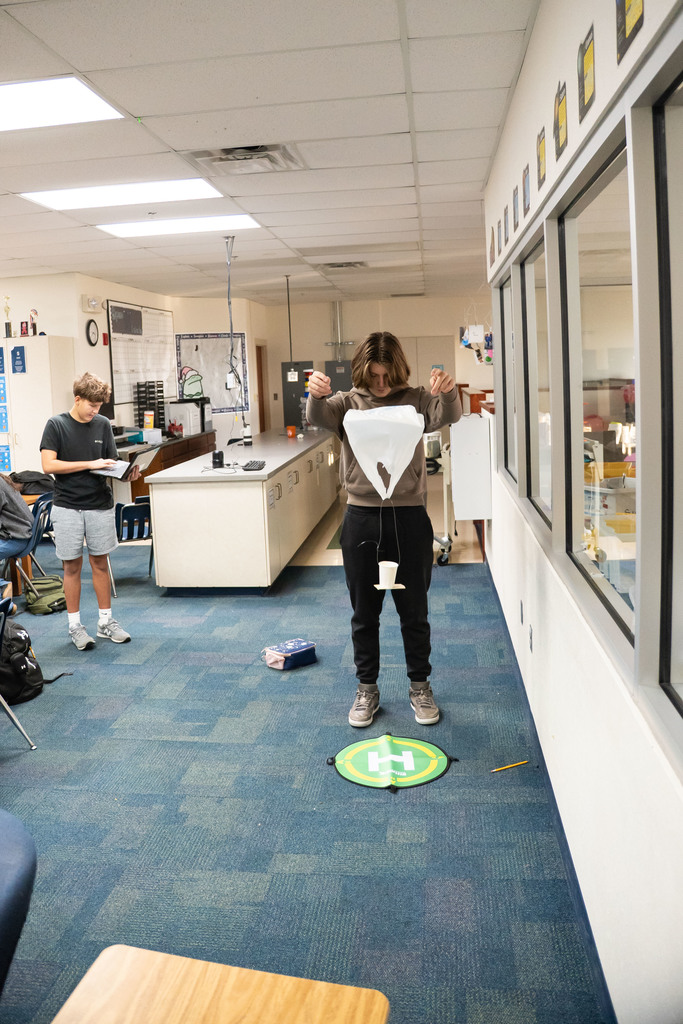 students testing out a science project by dropping it