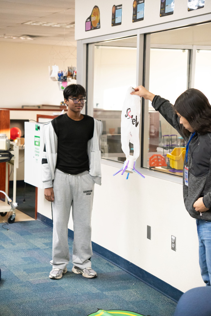 students testing out a science project by dropping it