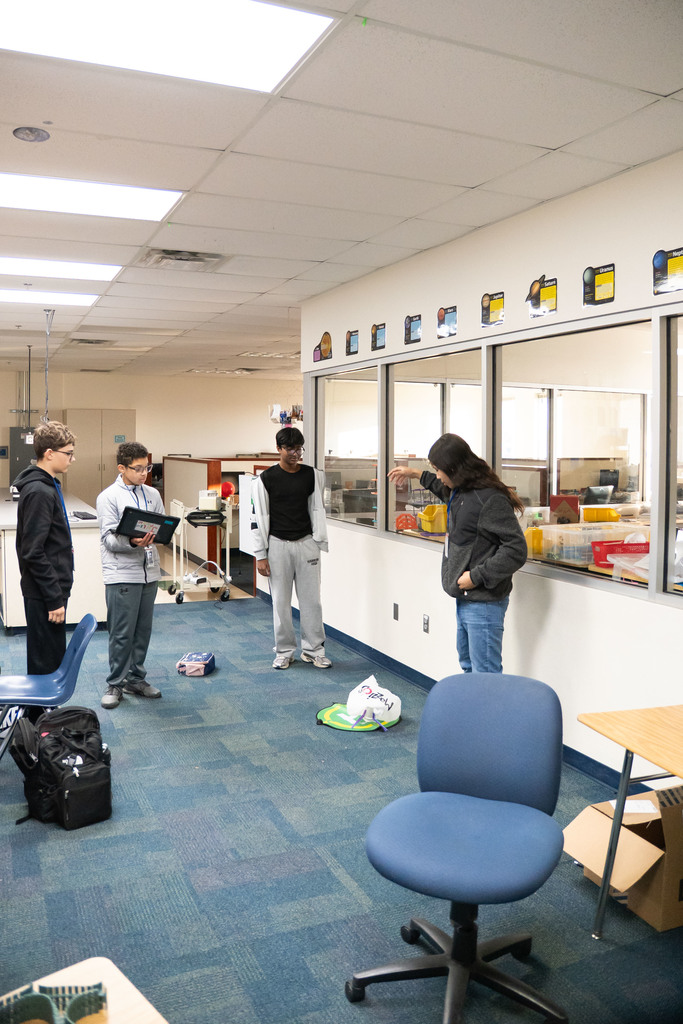students testing out a science project by dropping it