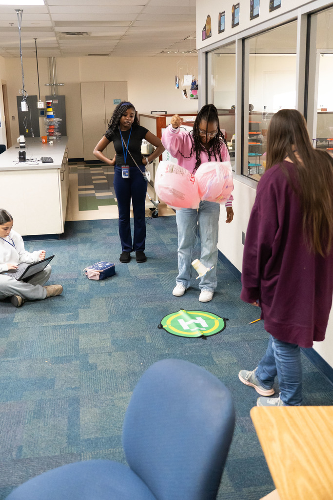 students testing out a science project by dropping it